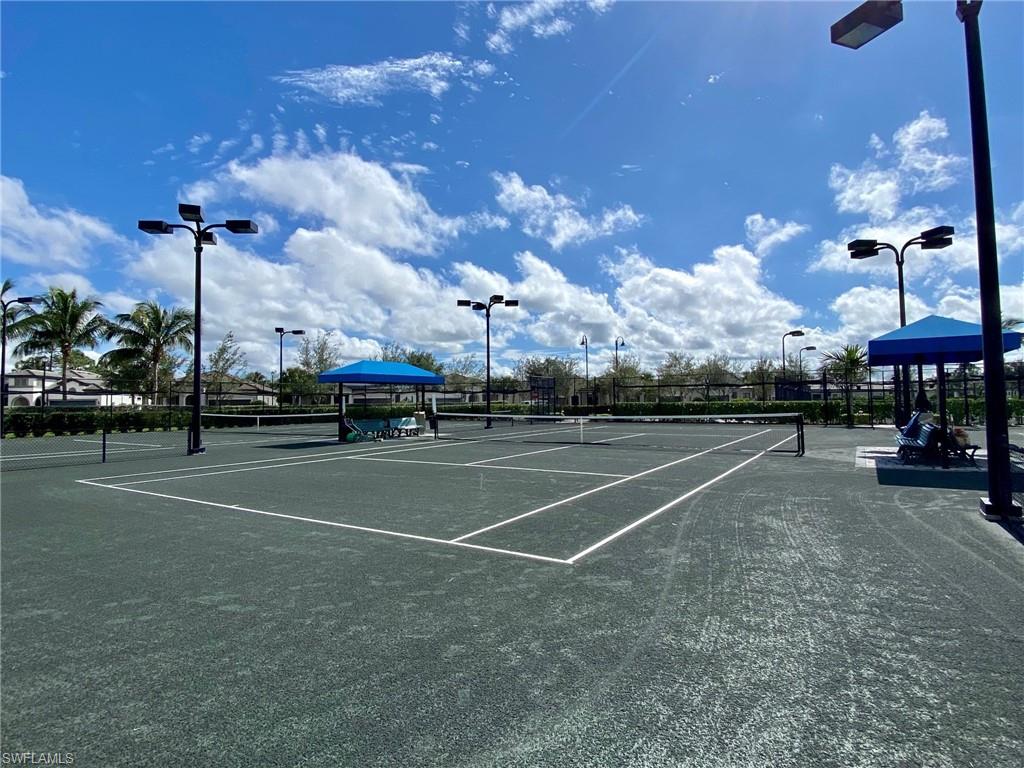 9431 Greyhawk Trail Naples, FL 34120 - Photo 48 of 50 a view of a tennis ground with a fountain