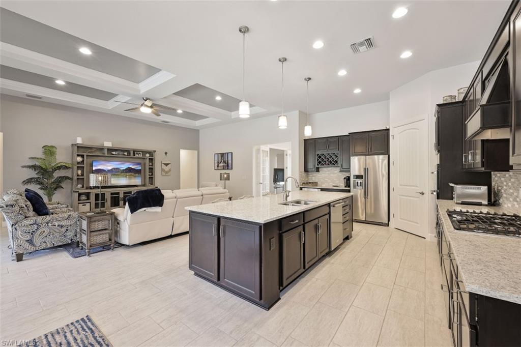 9431 Greyhawk Trail Naples, FL 34120 - Photo 5 of 50 a large white kitchen with a large counter top and stainless steel appliances