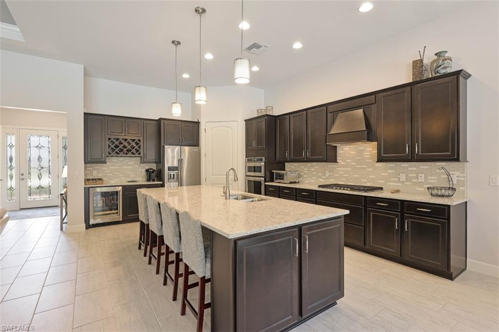 9431 Greyhawk Trail Naples, FL 34120 - Photo 7 of 50 a large kitchen with stainless steel appliances and a sink