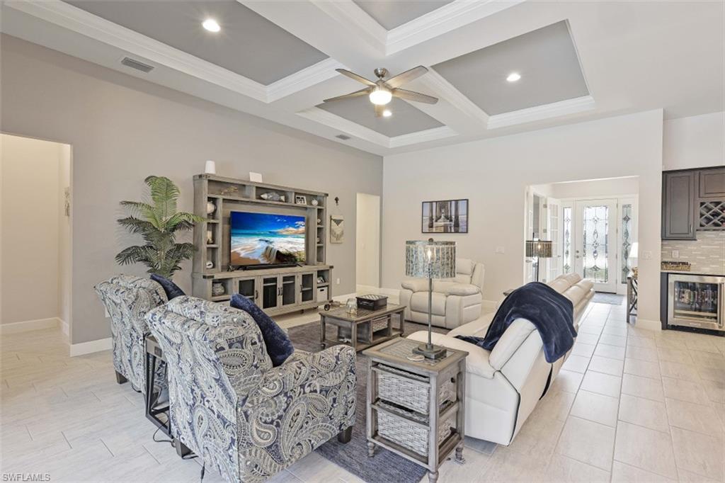 9431 Greyhawk Trail Naples, FL 34120 - Photo 10 of 50 a living room with furniture and a flat screen tv
