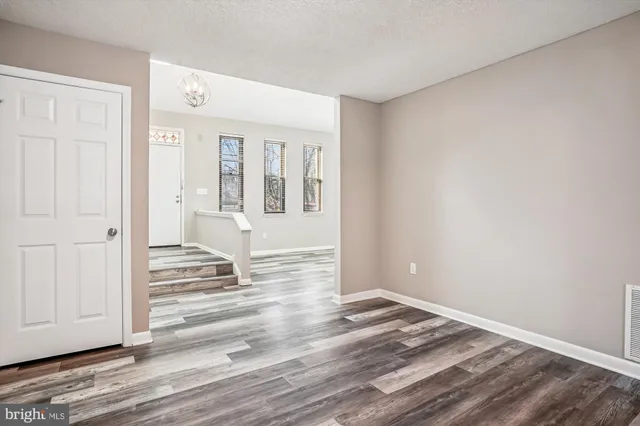 a view of a livingroom with wooden floor and white walls