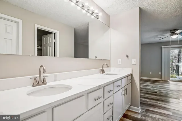 a spacious bathroom with a sink and a mirror