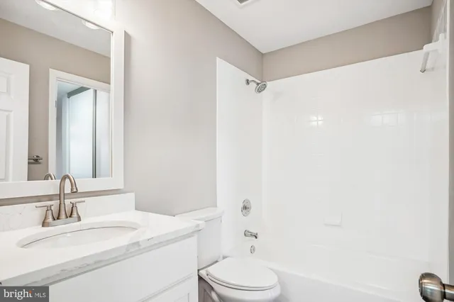 a bathroom with a shower curtain and a toilet