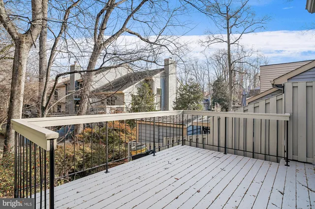 a view of a house with a door and wooden bench
