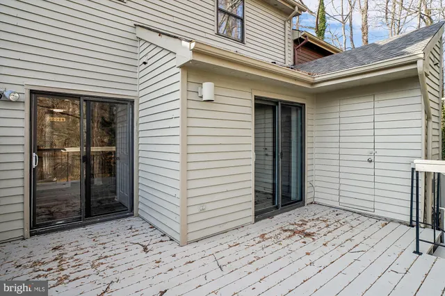 a view of balcony with wooden floor and fence