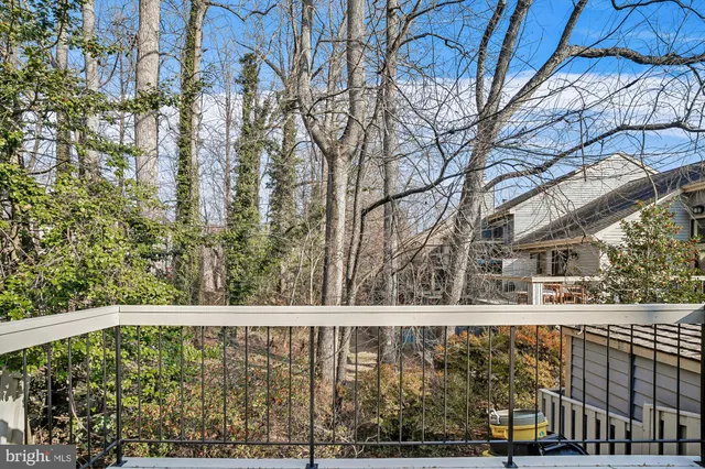 a balcony with trees in front of it