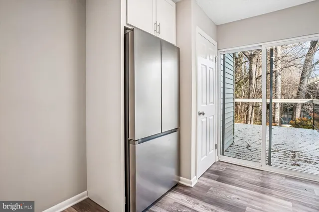 a view of entryway with wooden floor and door
