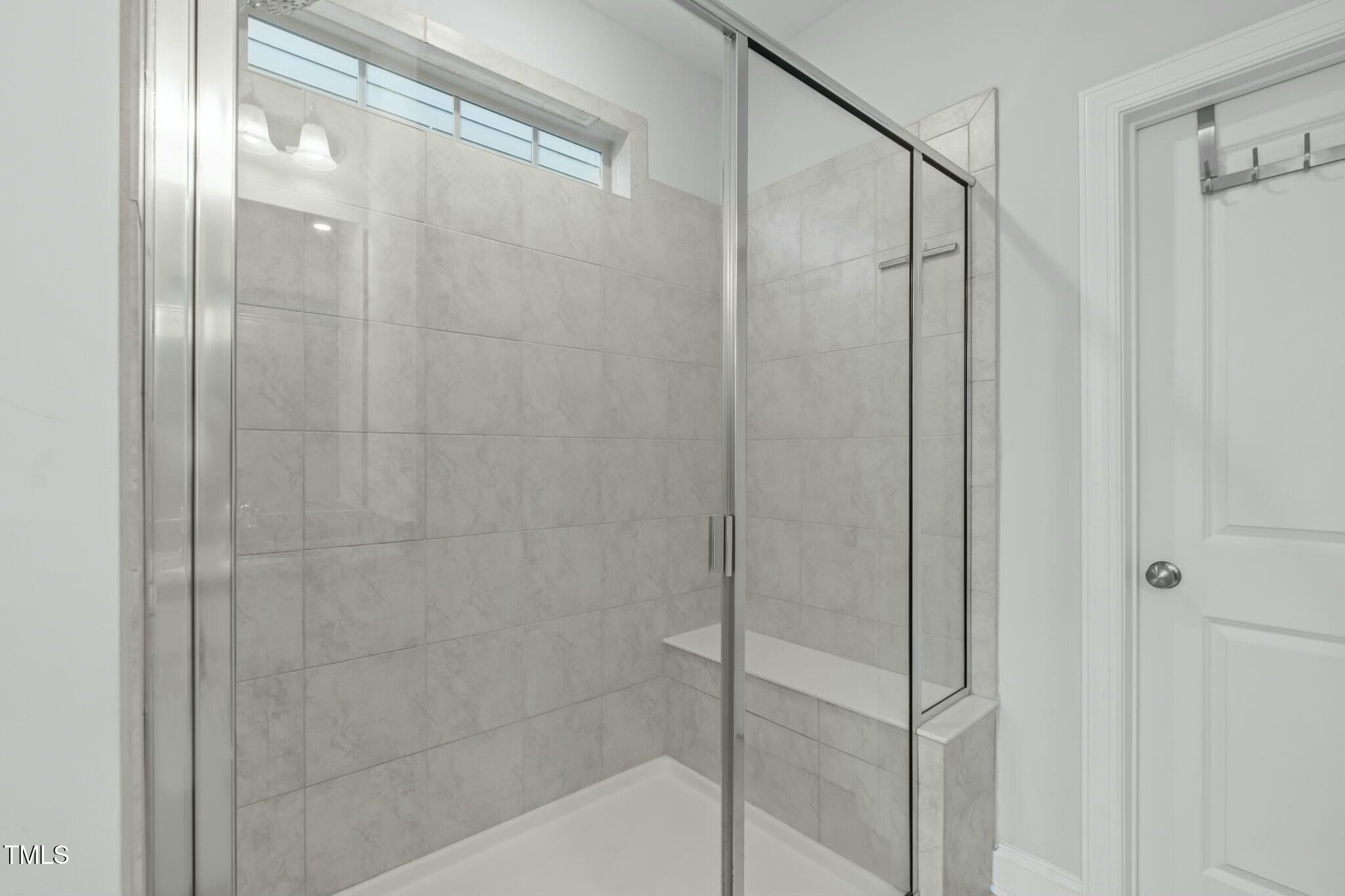 6417 Truxton Lane Raleigh, NC 27616 - Photo 25 of 47 a bathroom with a glass shower door