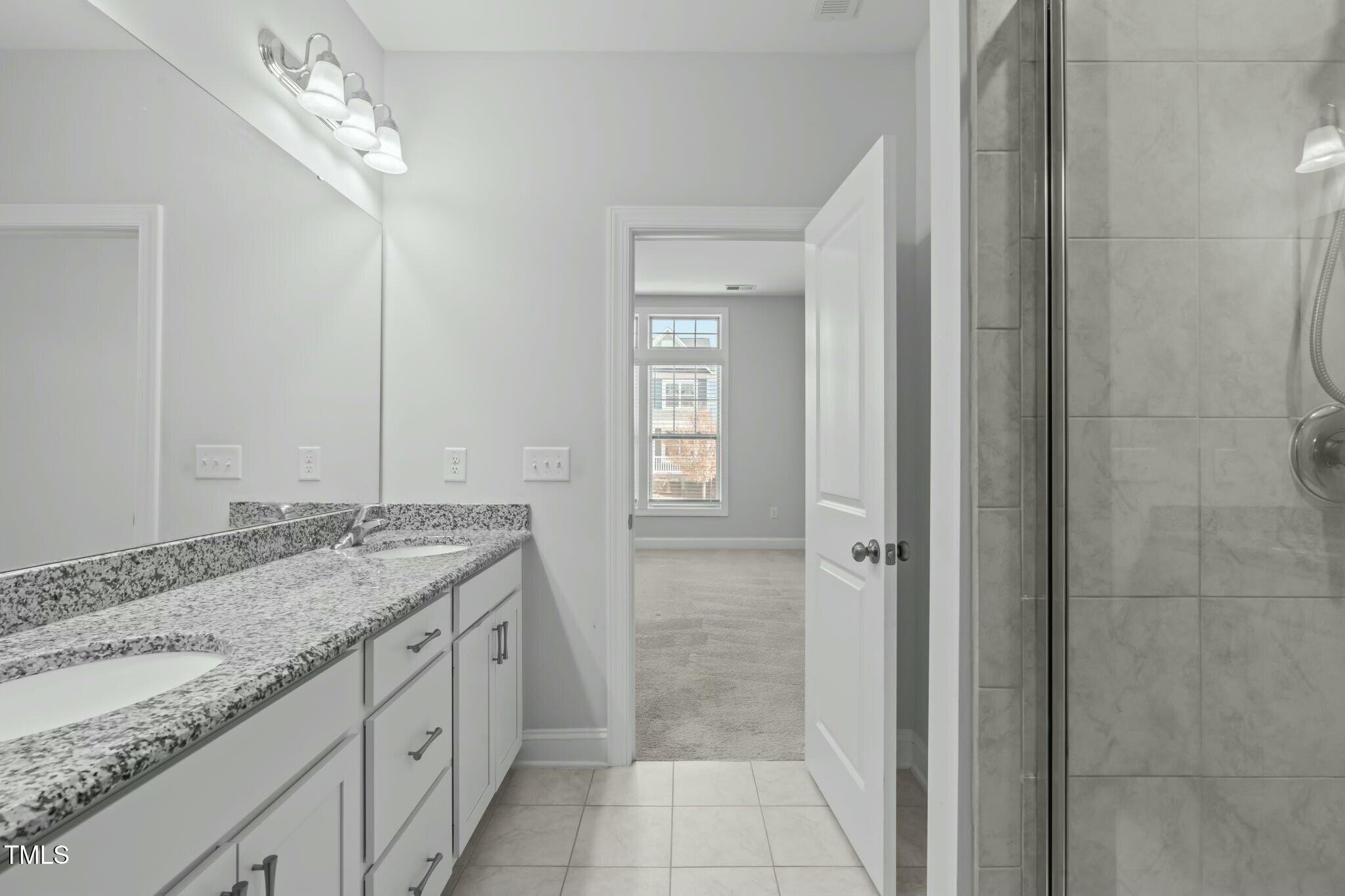 6417 Truxton Lane Raleigh, NC 27616 - Photo 26 of 47 a bathroom with a granite countertop sink and a mirror