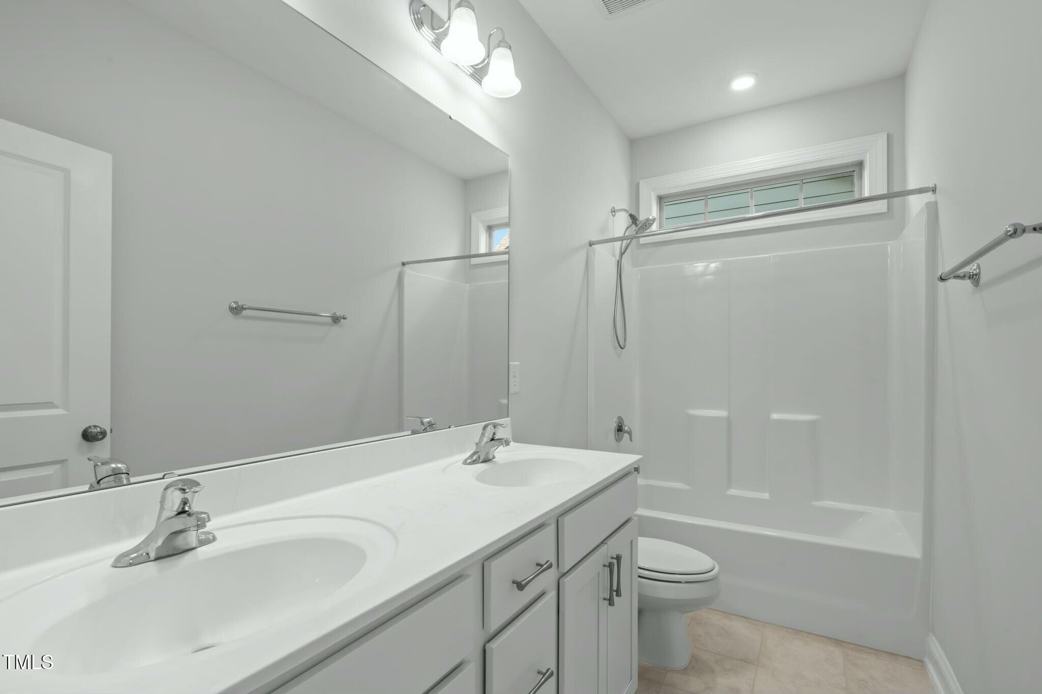 6417 Truxton Lane Raleigh, NC 27616 - Photo 34 of 47 a bathroom with a sink a toilet and shower