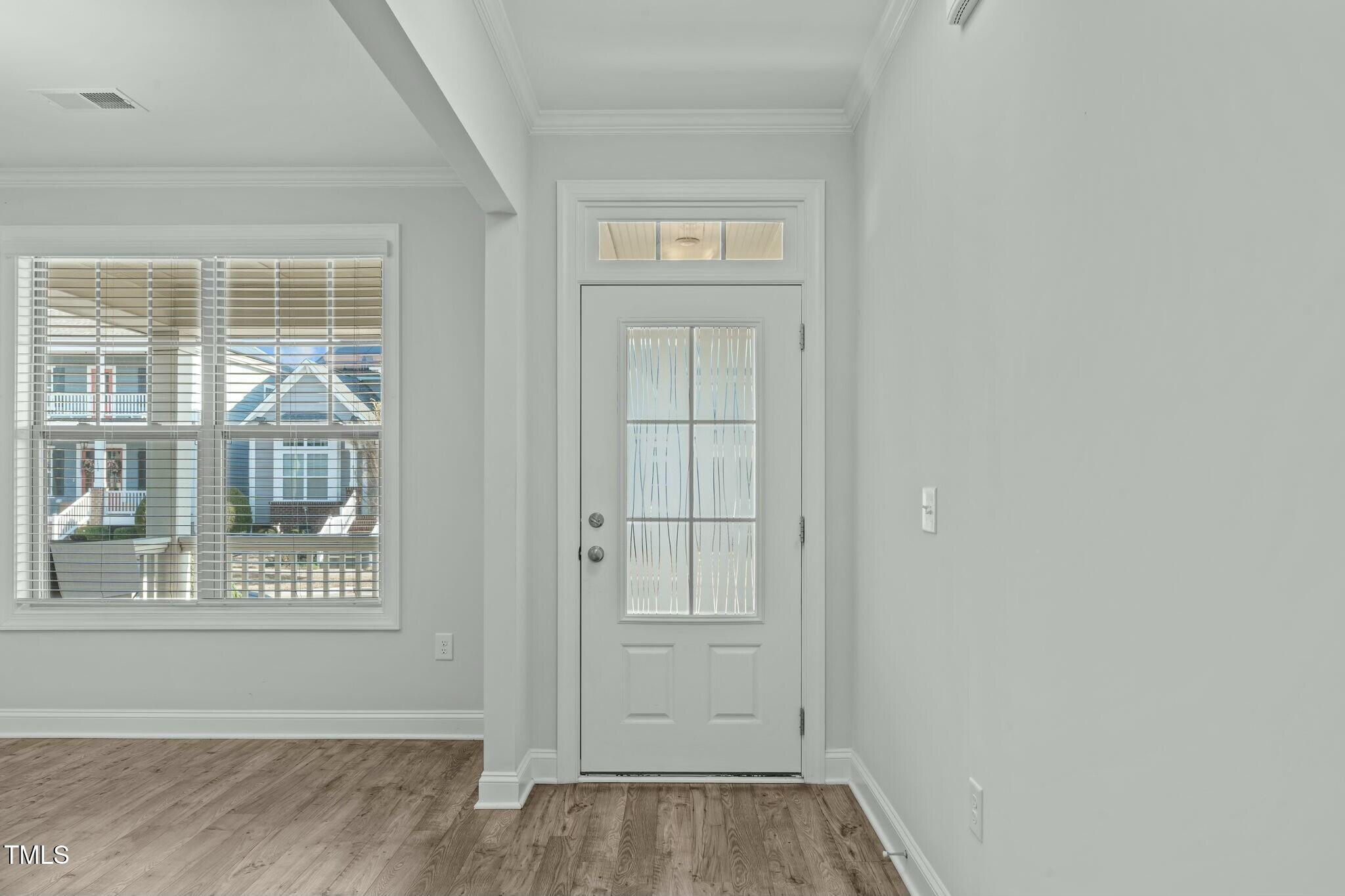 6417 Truxton Lane Raleigh, NC 27616 - Photo 4 of 47 an empty room with wooden floor and windows
