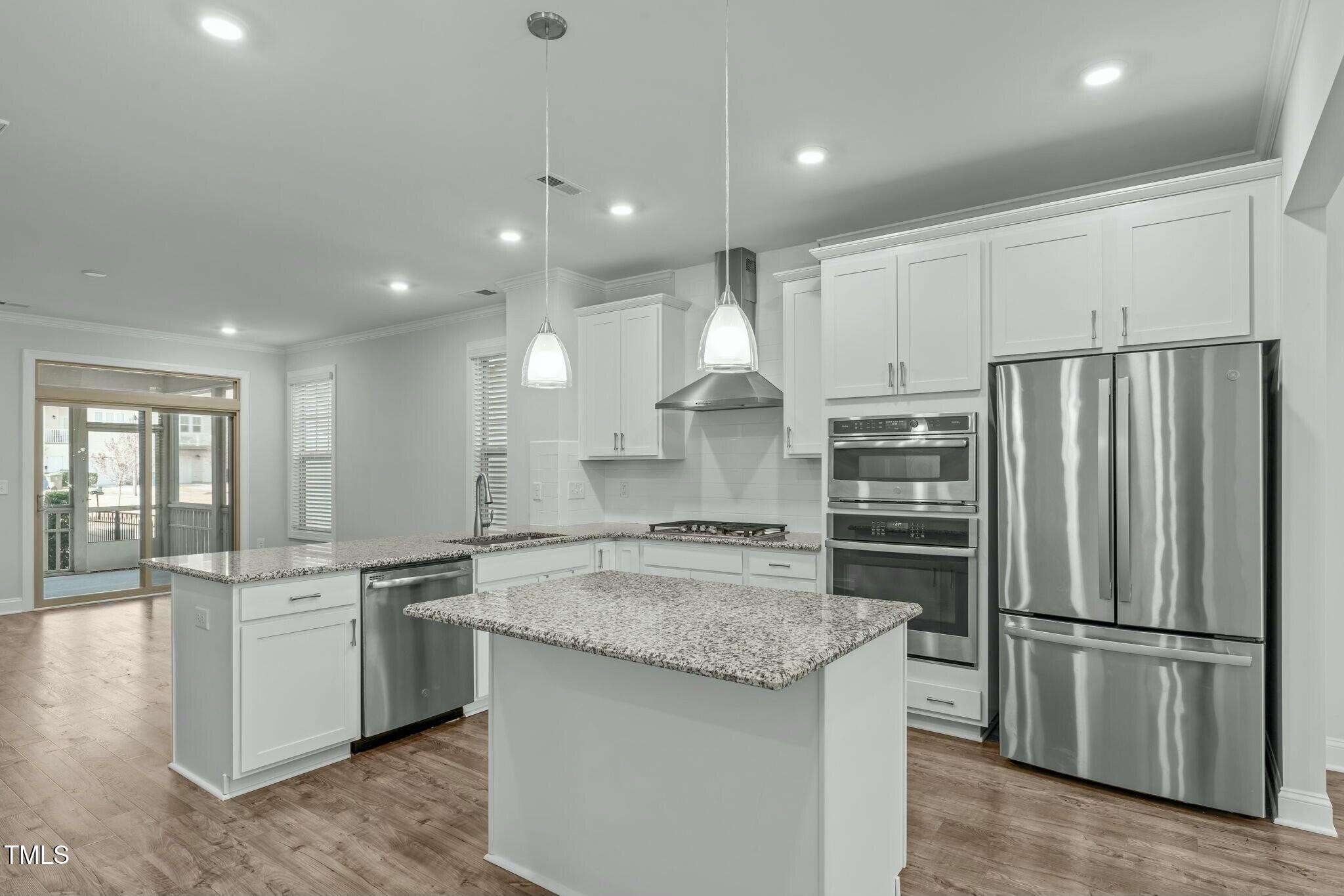 6417 Truxton Lane Raleigh, NC 27616 - Photo 9 of 47 a kitchen with stainless steel appliances granite countertop a refrigerator a sink a stove and white cabinets