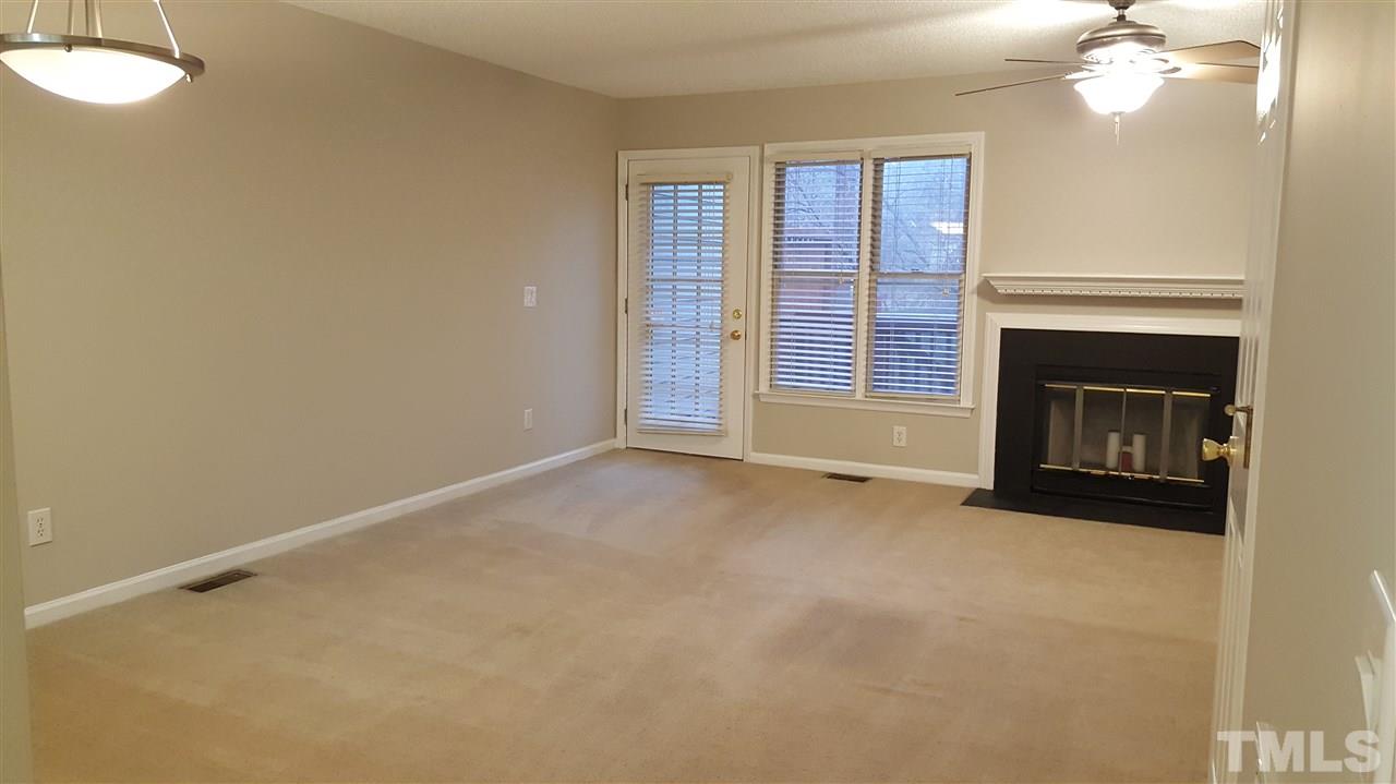 6036 Epping Forest Drive Raleigh, NC 27613 - Photo 3 of 21 Updated Light and Ceiling fan. Wood Burning fireplace, Privacy blinds, Coat Closet with additional under stairway storage