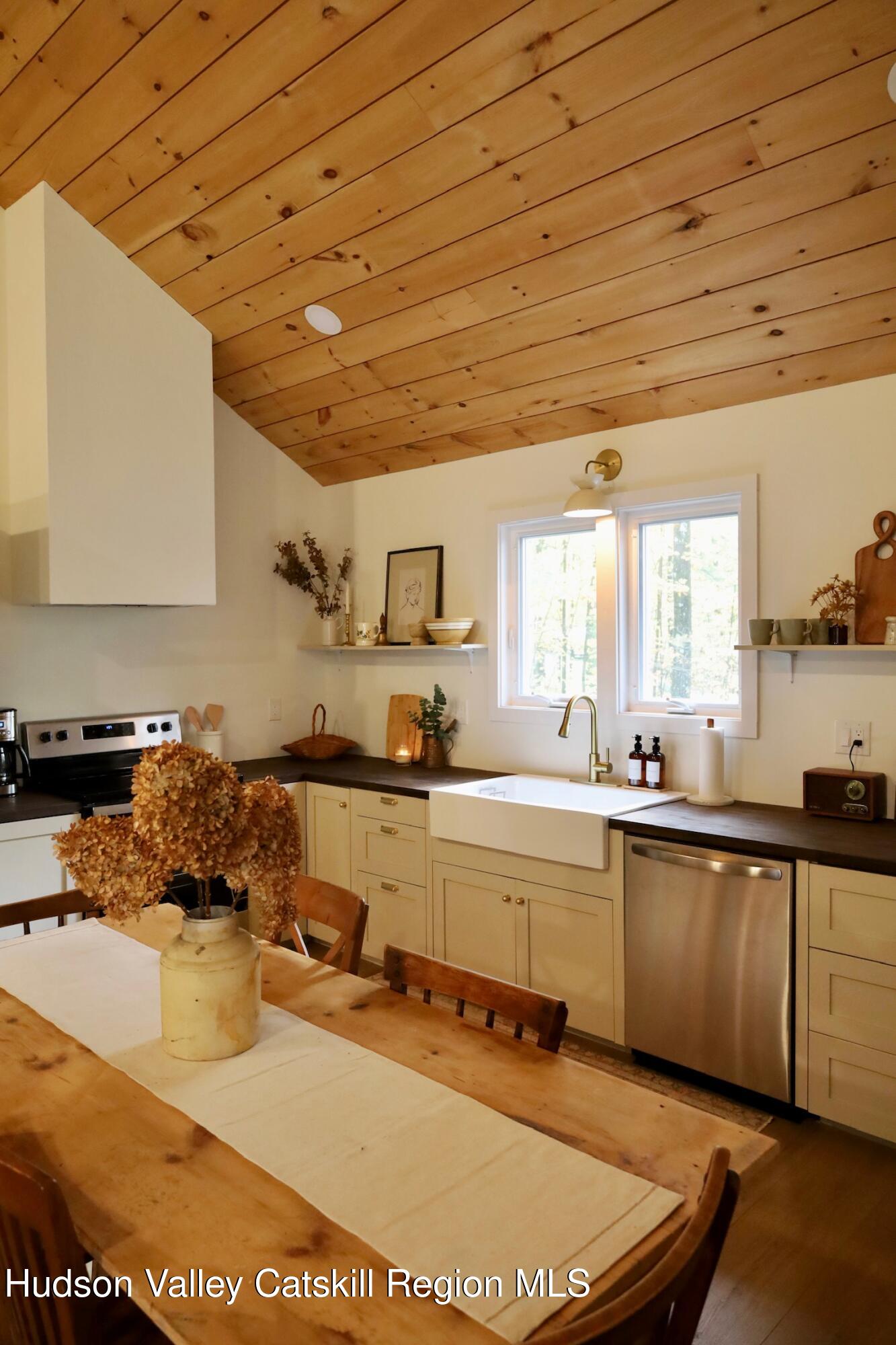 230 Potic Mountain Road Athens, NY 12414 - Photo 6 of 25 a kitchen with sink a stove and cabinets