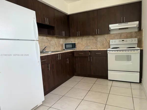 a kitchen with a cabinets and a stove top oven