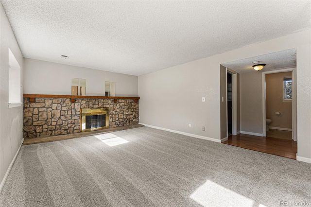 a view of an empty room with fire place