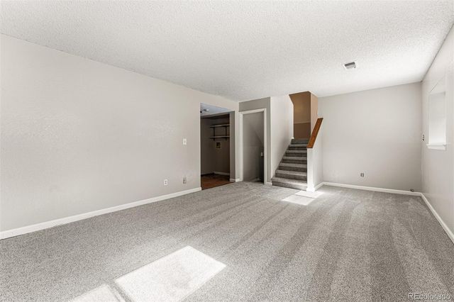 a view of an empty room with stairs