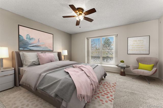 a bedroom with a bed and a couch