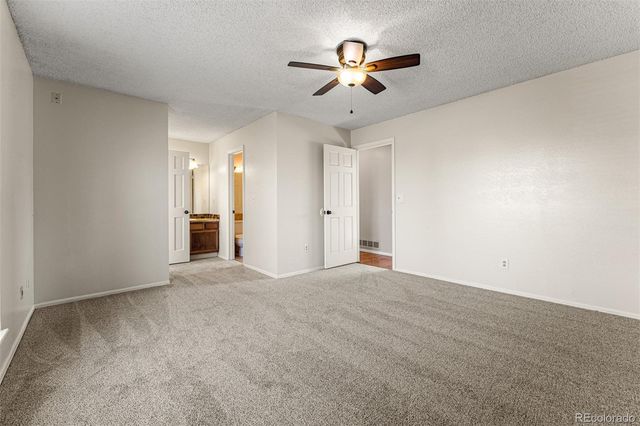 an empty room with a empty space and a ceiling fan