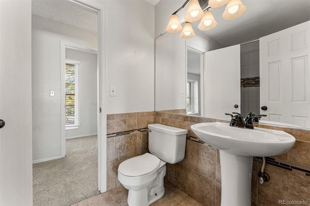a bathroom with a sink toilet and a mirror