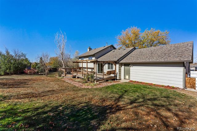 a view of a house with backyard and sitting area