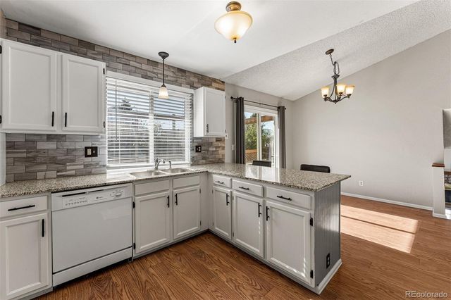 a kitchen with sink cabinets and wooden floor