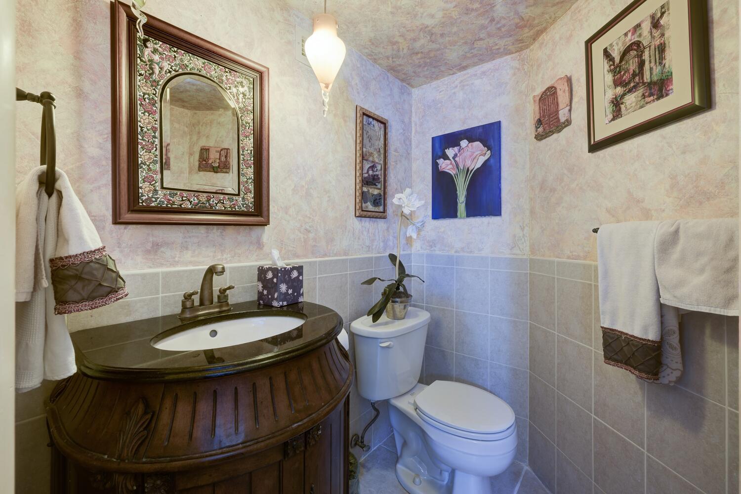 3800 Washington Road, Unit 1002 West Palm Beach, FL 33405 - Photo 14 of 20 a bathroom with a toilet a sink and mirror