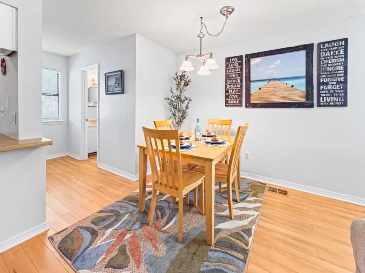 100 North Myrtle Drive, Unit 116 Santa Rosa Beach, FL 32459 - Photo 14 of 29 a view of a dining room with furniture wooden floor and chandelier