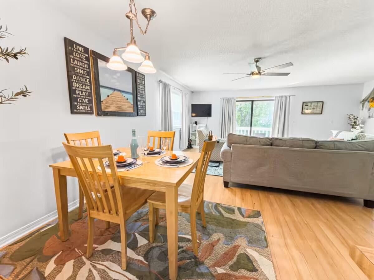 100 North Myrtle Drive, Unit 116 Santa Rosa Beach, FL 32459 - Photo 15 of 29 a living room with a dining table and chairs with wooden floor