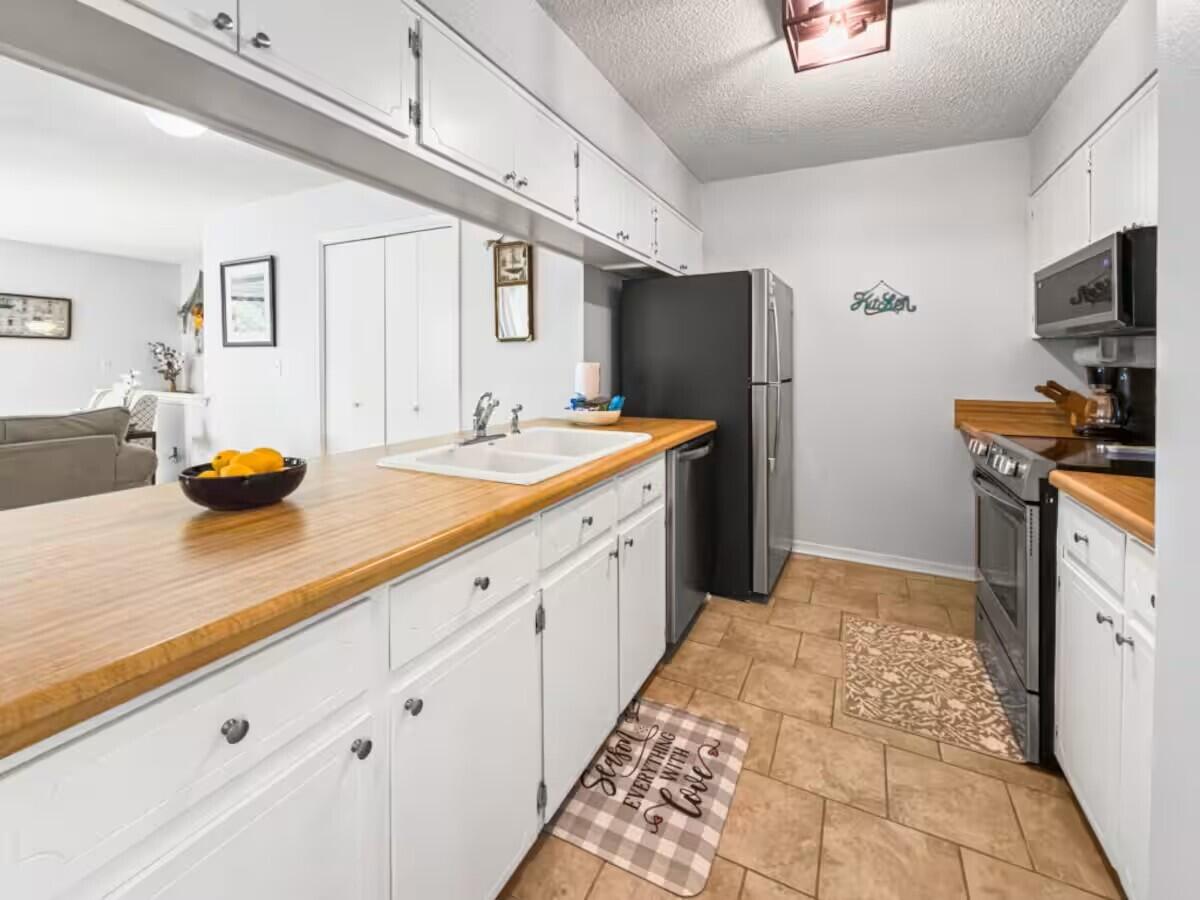 100 North Myrtle Drive, Unit 116 Santa Rosa Beach, FL 32459 - Photo 16 of 29 a kitchen with a sink appliances and cabinets