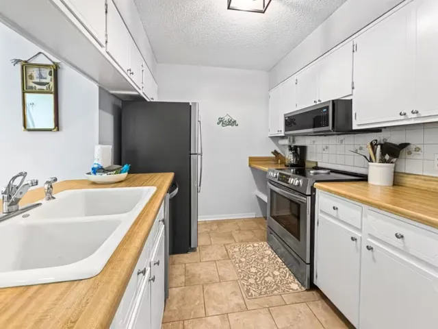 a kitchen with a sink stove and refrigerator