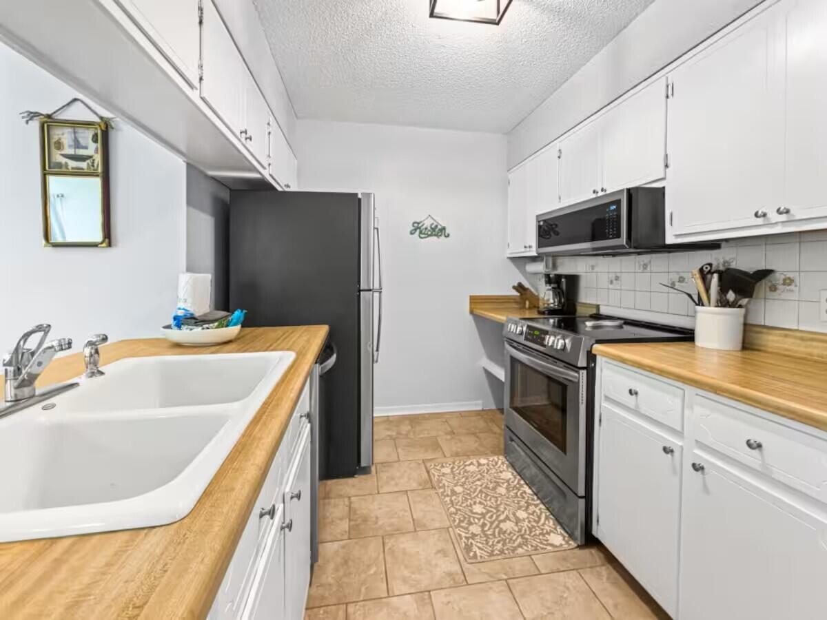 100 North Myrtle Drive, Unit 116 Santa Rosa Beach, FL 32459 - Photo 17 of 29 a kitchen with a sink stove and refrigerator