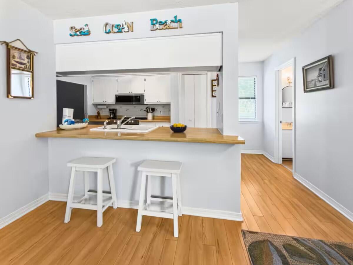 100 North Myrtle Drive, Unit 116 Santa Rosa Beach, FL 32459 - Photo 18 of 29 a dining table with chair and wooden floor
