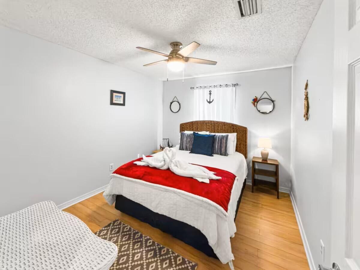 100 North Myrtle Drive, Unit 116 Santa Rosa Beach, FL 32459 - Photo 8 of 29 a bedroom with a bed and wooden floor
