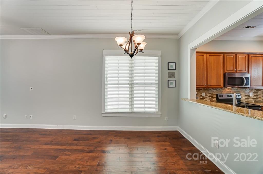 2619 Nations Commons Street Fort Mill, SC 29708 - Photo 8 of 28 a view of a room with wooden floor a ceiling fan and windows