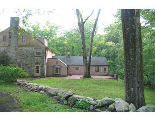 131 Old Mill Road Greenwich, CT 06831 - Photo 8 of 13 a view of a front of house with a big yard and large trees