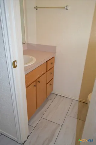 a bathroom with a granite countertop shower and sink