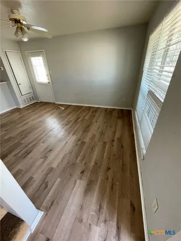 wooden floor in an empty room with a window