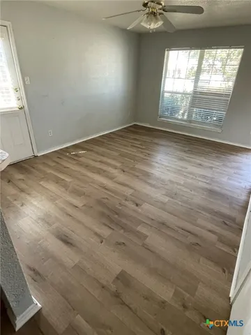 wooden floor in an empty room with a window