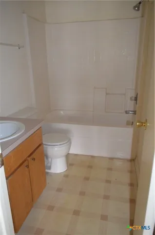 a bathroom with a bathtub and toilet