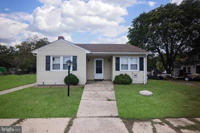 a front view of a house with garden and porch