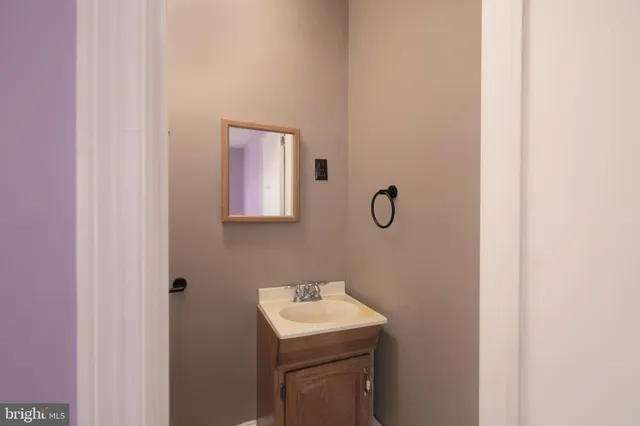 a bathroom with a sink toilet and mirror