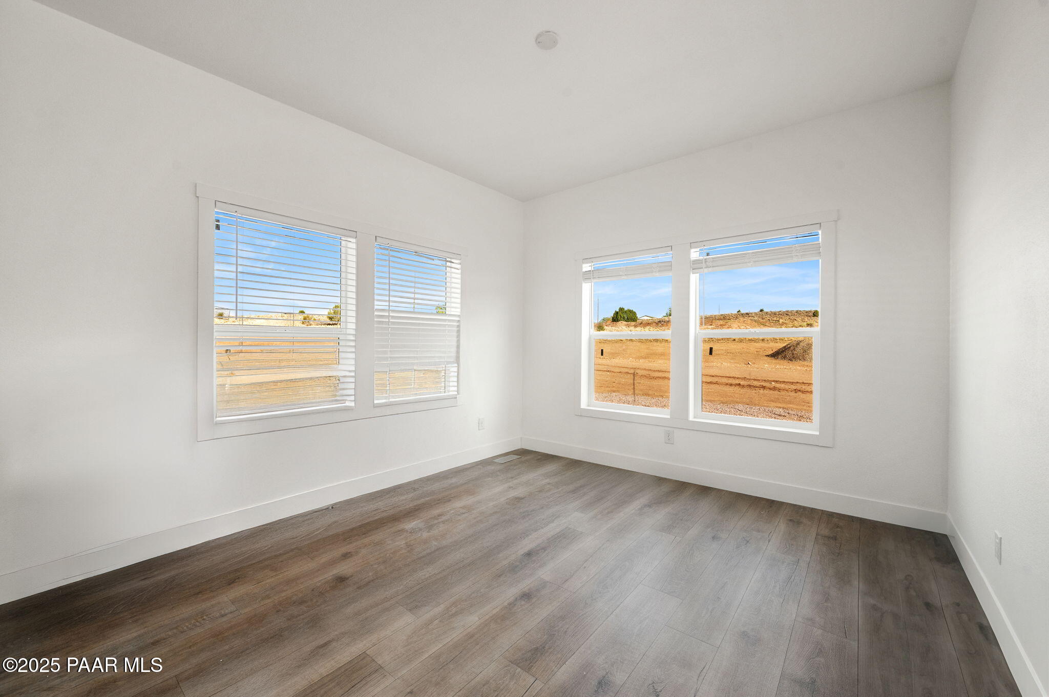 29 East Abra Road Paulden, AZ 86334 - Photo 9 of 22 a view of an empty room with wooden floor and a window