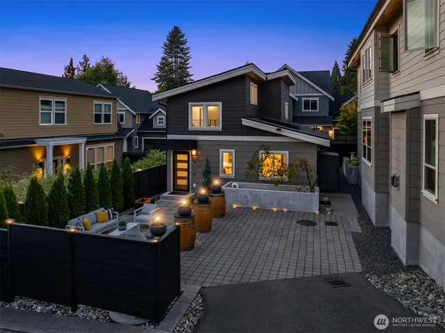 a view of a house with backyard and sitting area