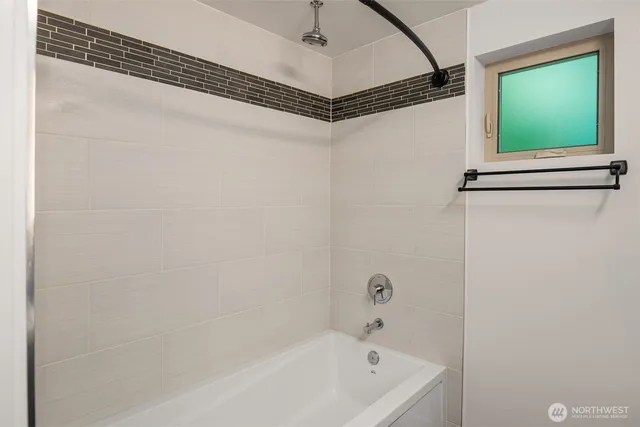 a bathroom with a bathtub and a shower