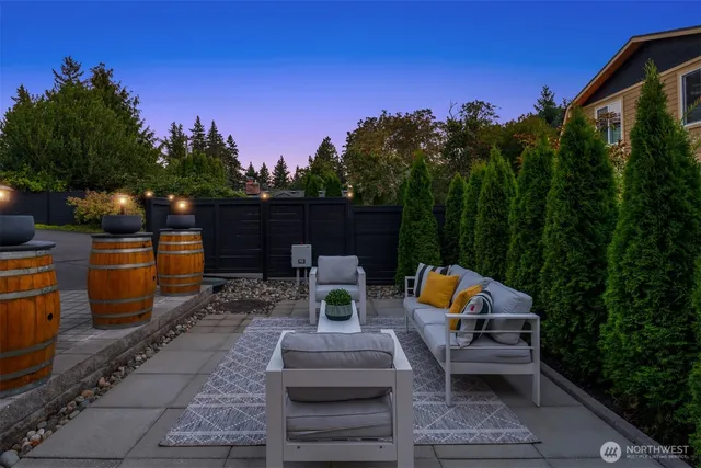 a backyard of a house with fire pit and outdoor seating