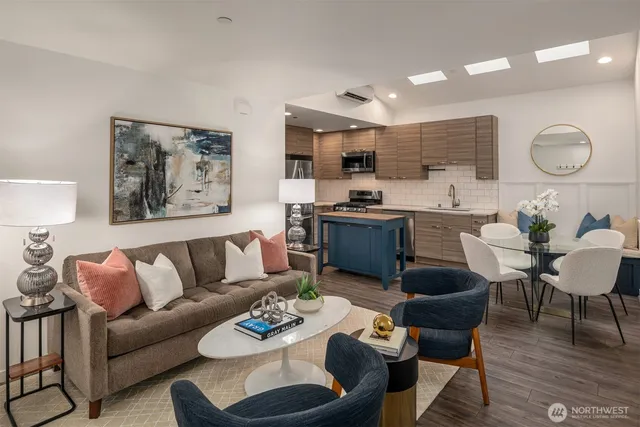 a living room with furniture kitchen view and a table