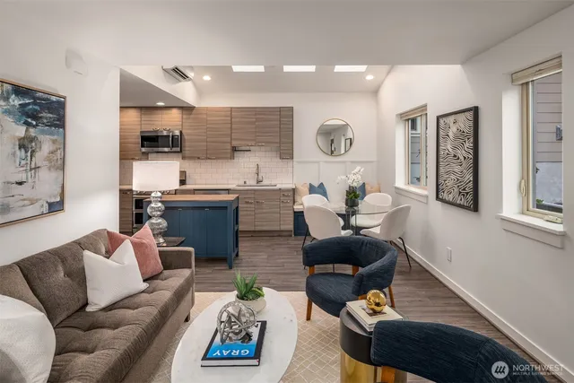 a living room with furniture kitchen and a window