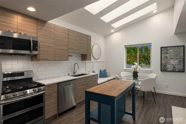 a kitchen with a stove a sink and a microwave