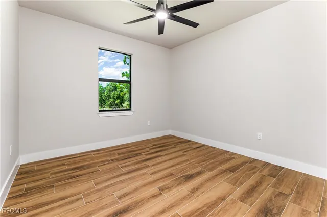 wooden floor in an empty room with a window